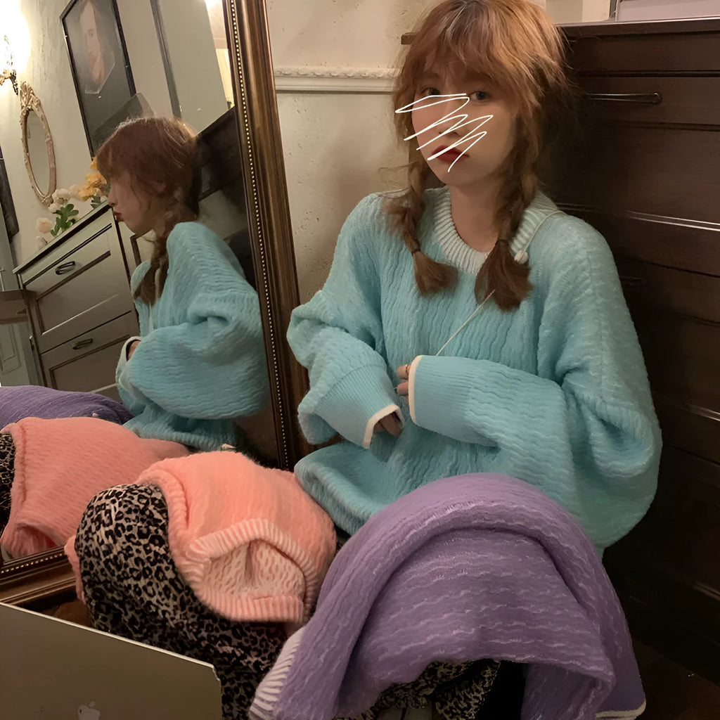Women's loose retro-style pullover sweater in a solid colour, shown in lake blue.