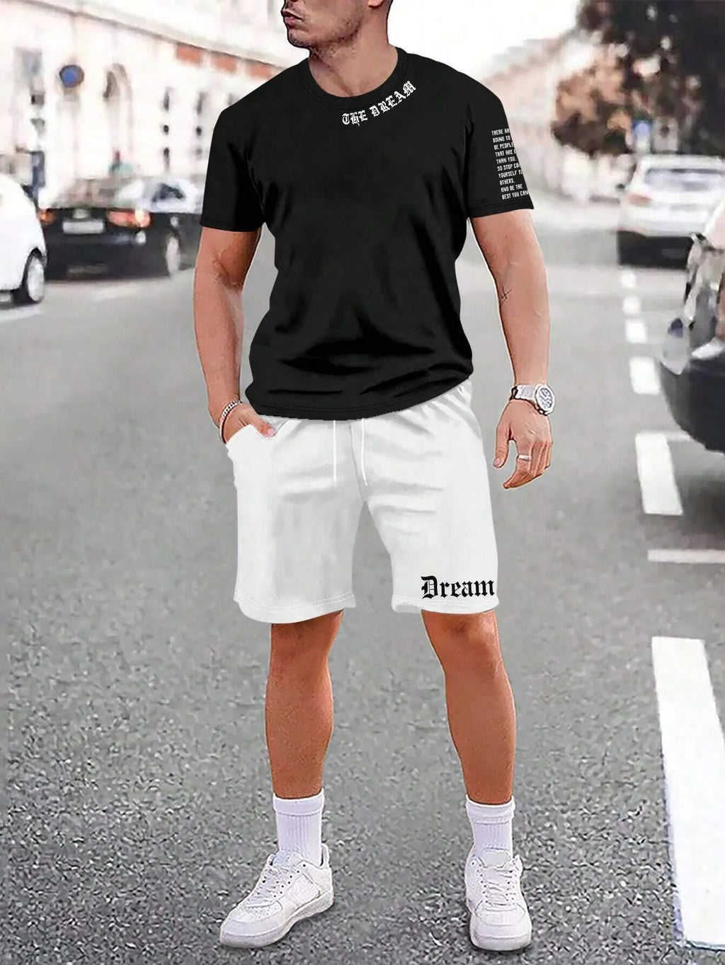 Man wearing a printed short-sleeve top and matching shorts from a sports style suit set.