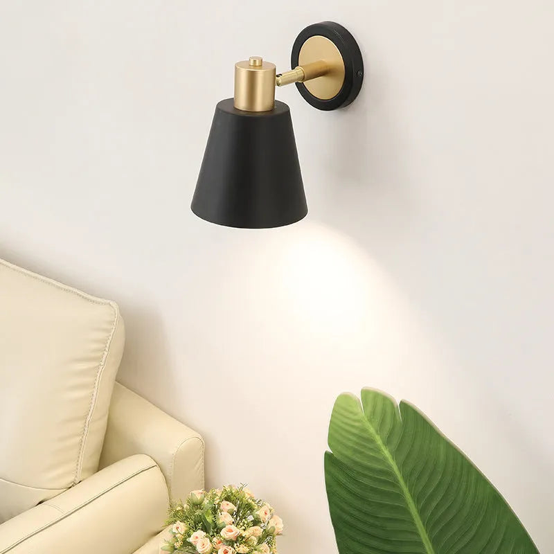Nordic style iron wall lamp with adjustable LED light on a plain wall.