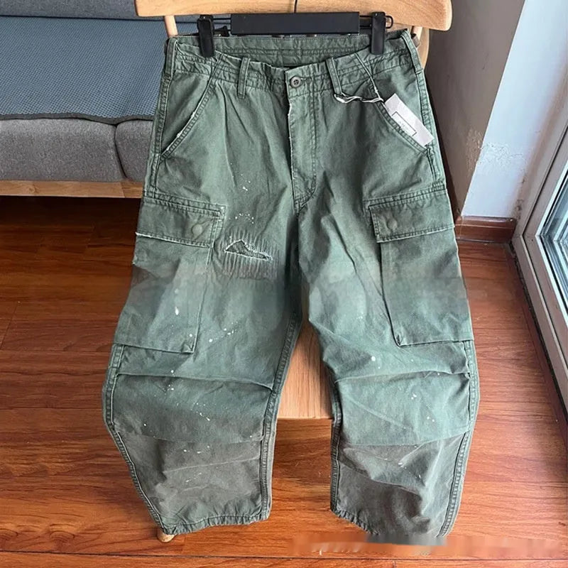 Men's loose fit washed cotton paratrooper pants in Army Green with large pockets, flat lay