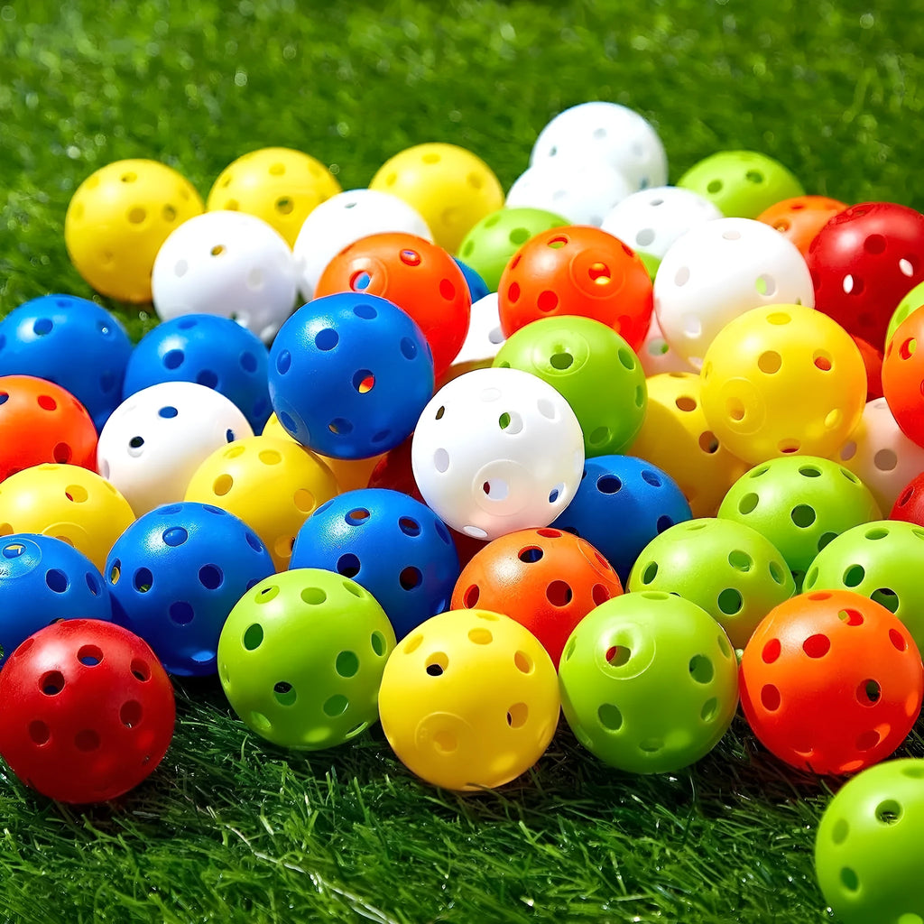 Multi-colour golf practice balls with 26 holes on a green surface.