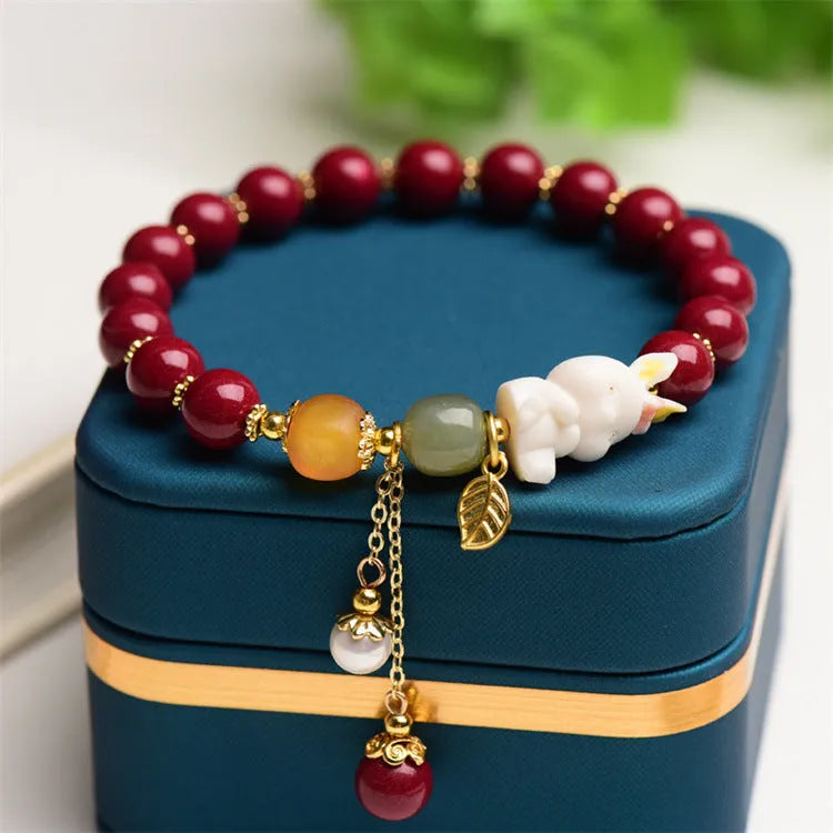 Natural cinnabar bracelet with rabbit design in purple gold sand colour, showing 8mm and 10mm bead size options.