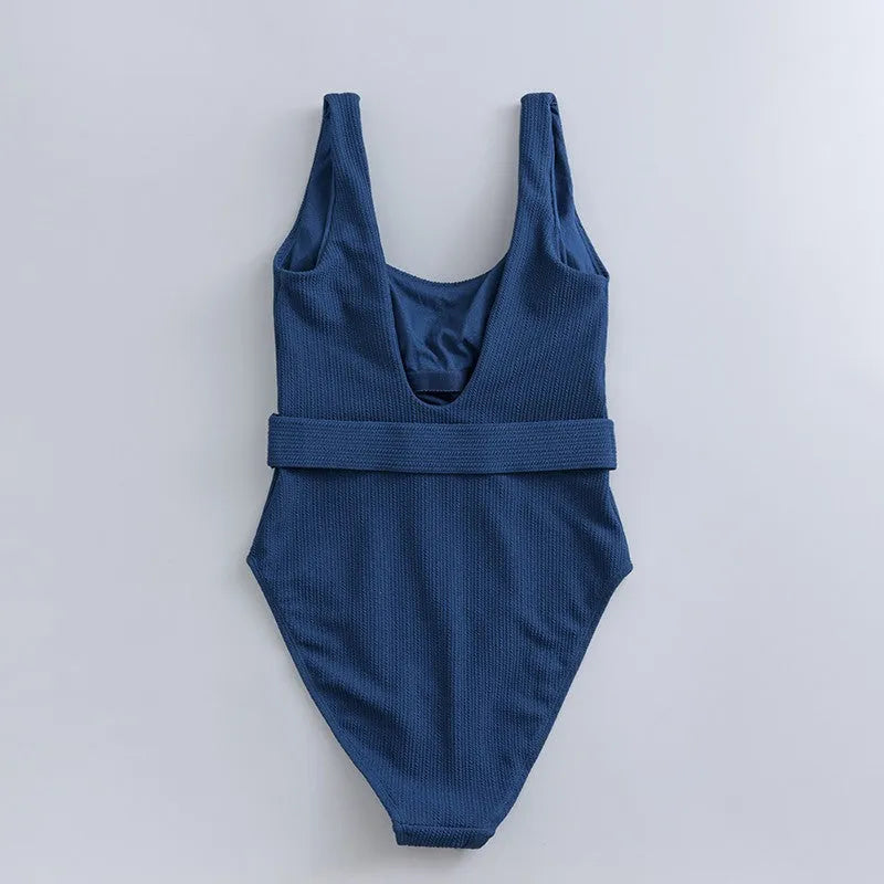 Navy blue women's one-piece swimsuit with triangle cut and chest pads on size chart