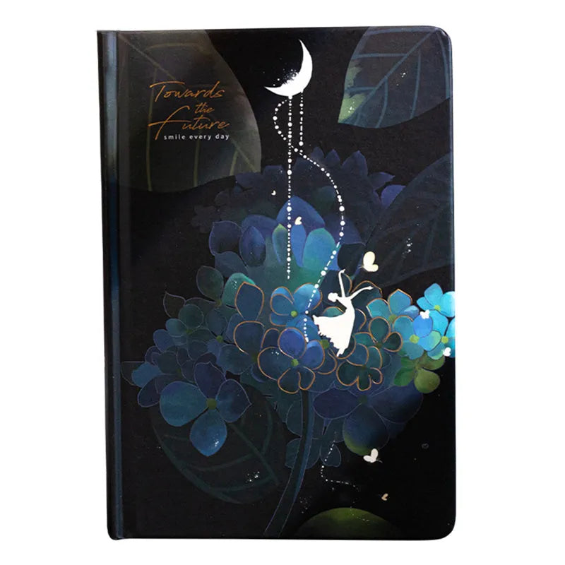 A5 diary book with a luminous purple cover, open to show pages with colour illustrations.