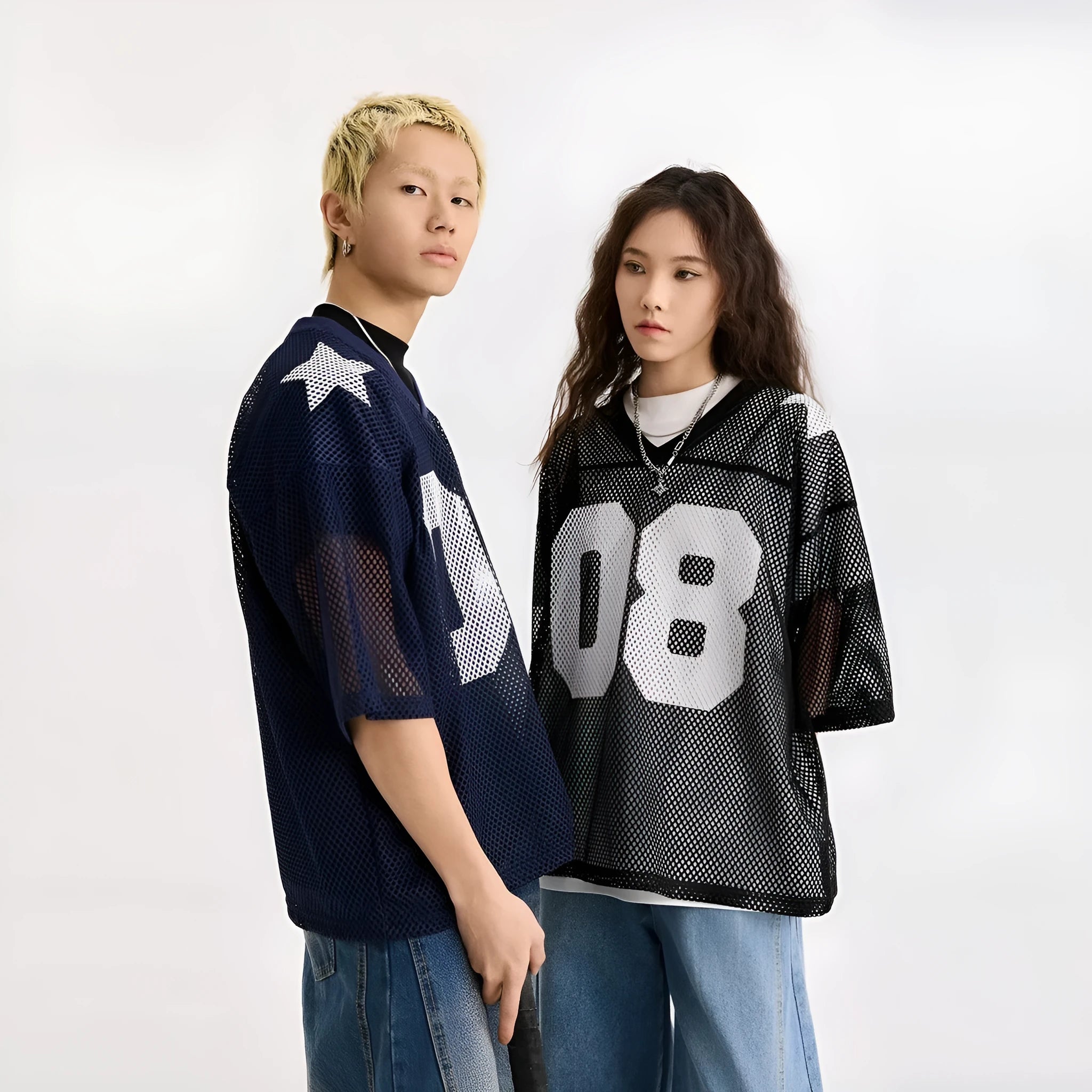 Loose fit black pullover shirt with white letters pattern print, short sleeves, on a hanger.
