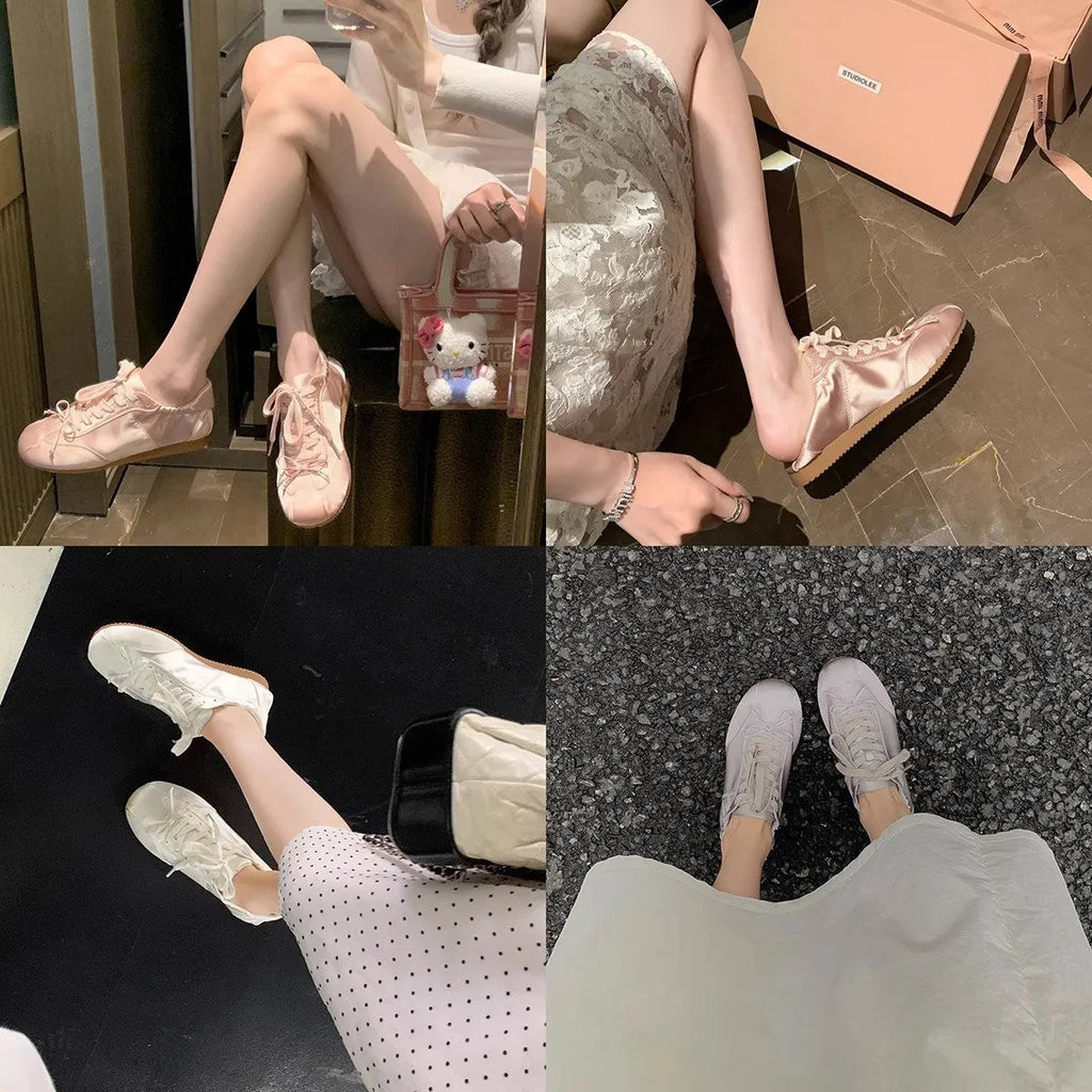 Women's silver grey satin ballet flat shoes with front lace-up design and round toe.