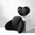Black memory foam triangle lumbar support pillow and headrest on a car seat.
