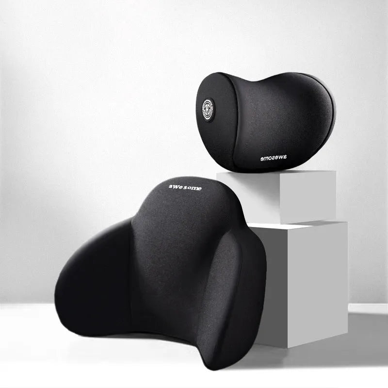 Black memory foam triangle lumbar support pillow and headrest on a car seat.