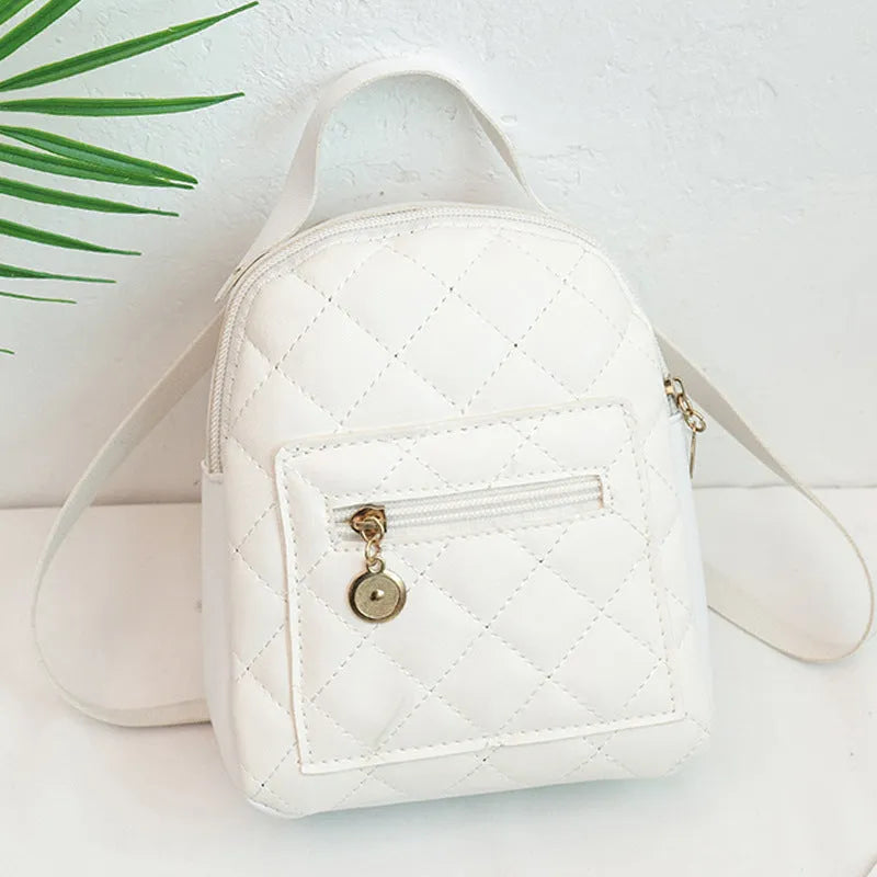A white hard-shell girls backpack with embroidery, showing its square shape and soft top handle.