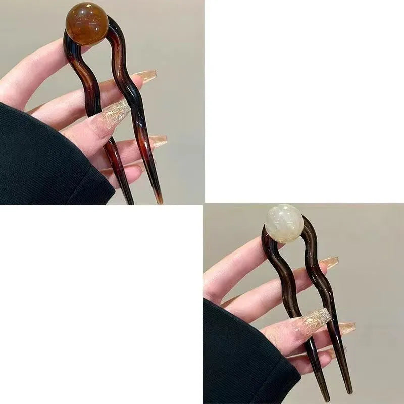 U-shaped hair barrettes with retro ball design in acrylic material showing colour options
