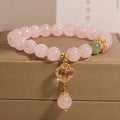Pink crystal bracelet for women with a four-leaf clover pendant, alloy inlay, and rhinestones.
