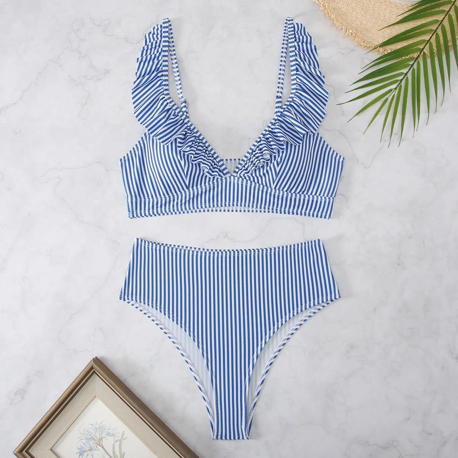 Black and white striped bikini swimsuit with a split chest design.