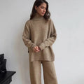 Women's dark grey side-slit knit top and matching trousers, a two-piece acrylic suit set laid flat.