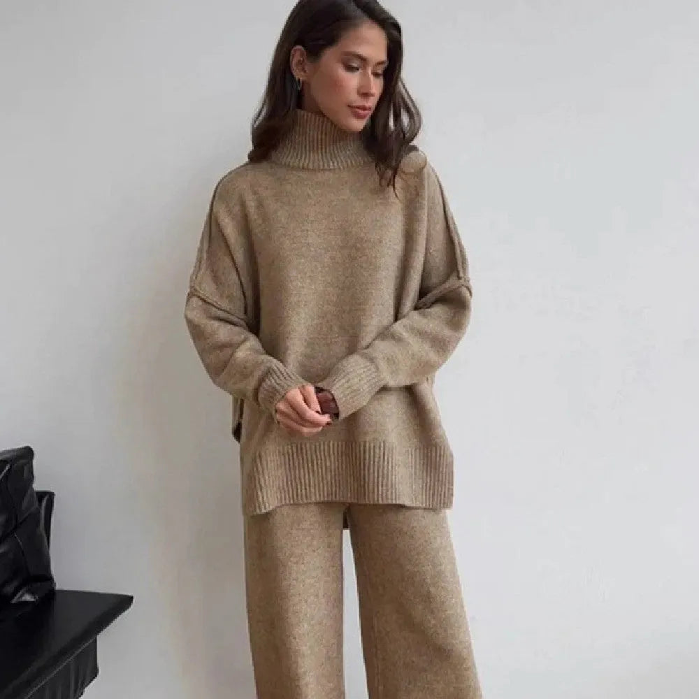 Women's dark grey side-slit knit top and matching trousers, a two-piece acrylic suit set laid flat.