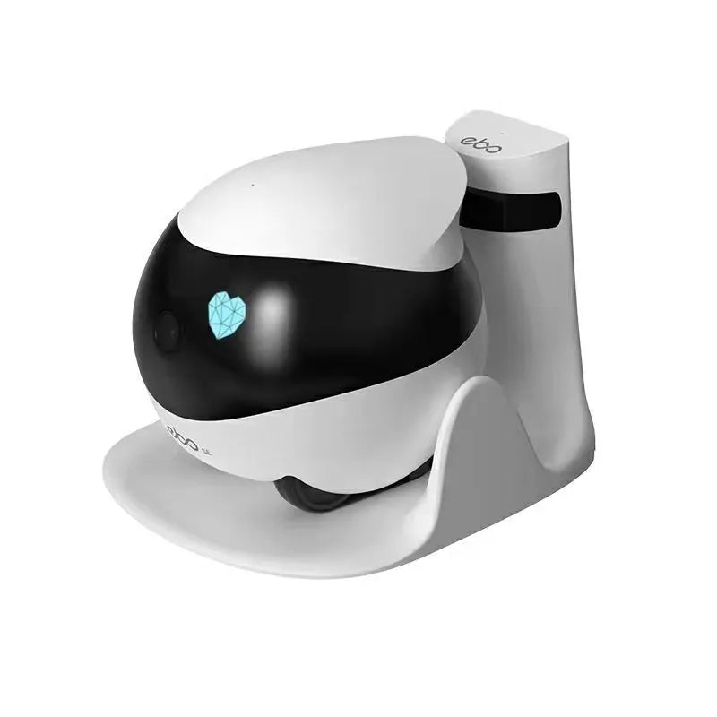 White cube-shaped mobile robot camera with camera lens on a flat surface next to its docking station.