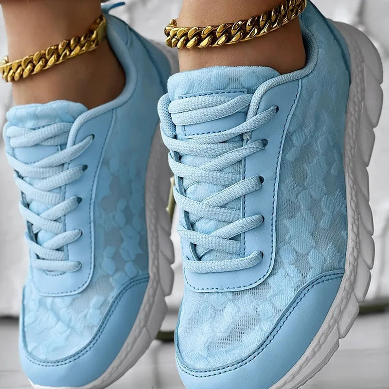 Women's lightweight canvas running shoes with soft sole in white, black, blue, or pink colour options.