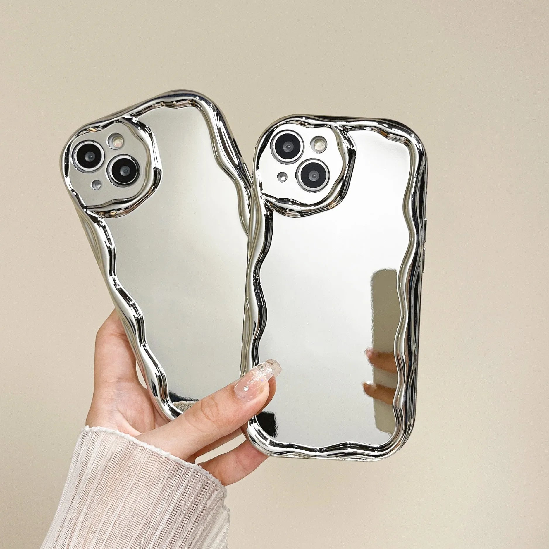 Silver electroplated cream grain silicone phone case with bracelet on a white background