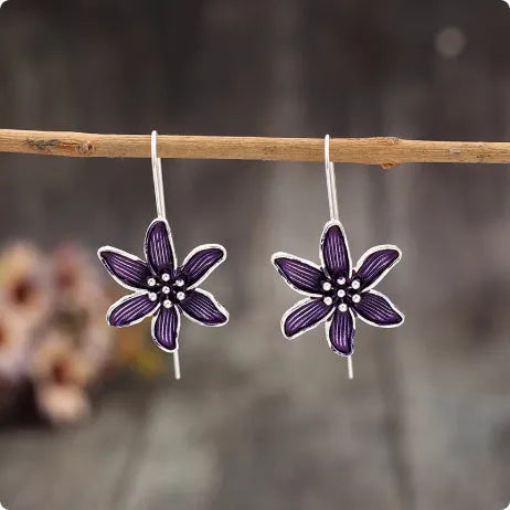 A pair of purple flower-shaped alloy earrings with a retro elegant design.