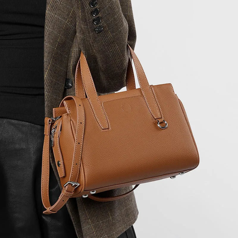 Genuine leather crossbody bag in horizontal square design with single strap, shown in black colour option.