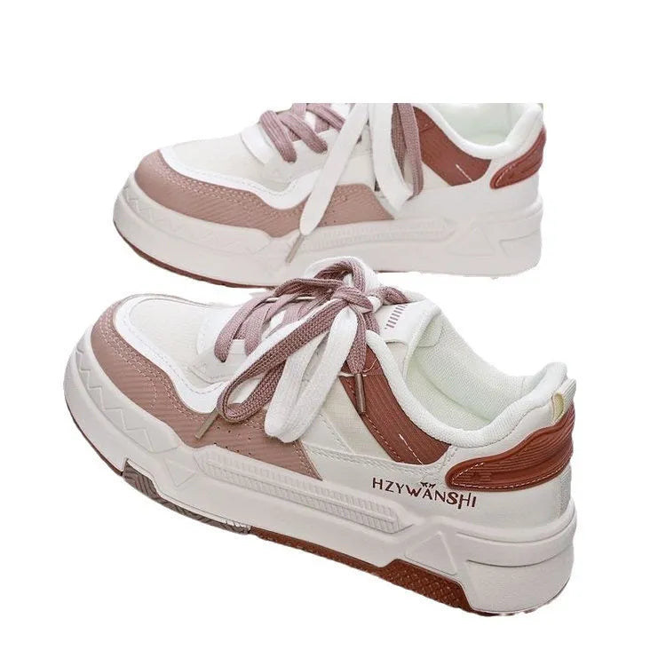 Beige children's lace-up trainers with cross straps over instep and thick rubber sole.