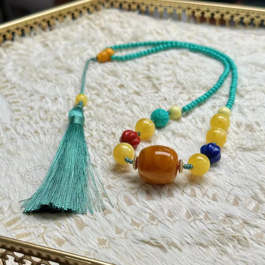 Turquoise necklace with a hand-woven stone mesh flower lucky pendant on a ball bead chain.