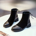 Black women's knee-high martin boots with side zipper and round toe on a rubber sole.