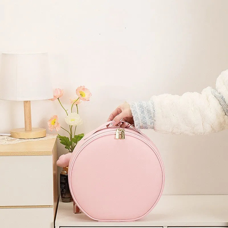 Round black smart LED makeup bag with lighted mirror open, showing internal partitions.