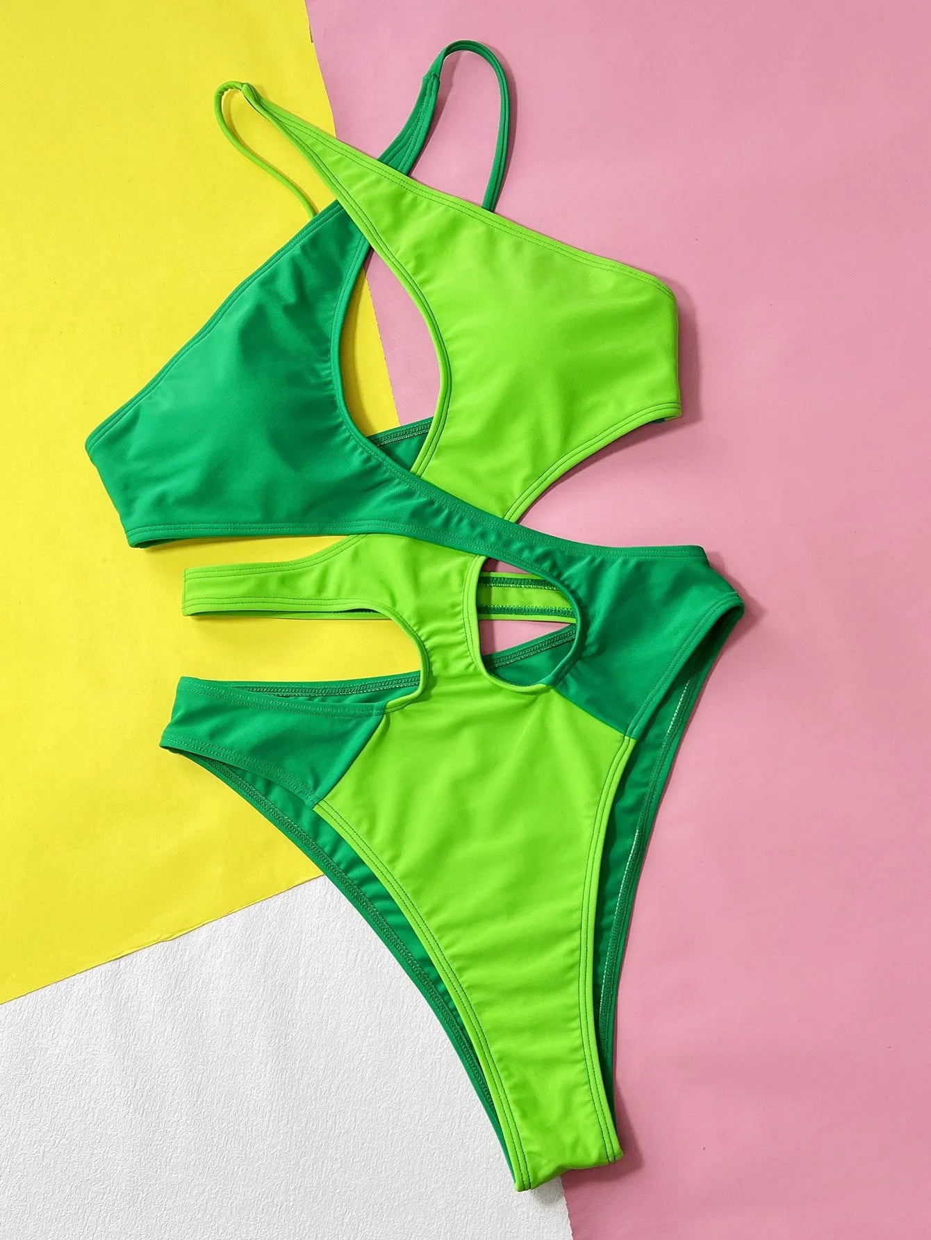 Solid green women's one-piece nylon swimsuit on a hanger