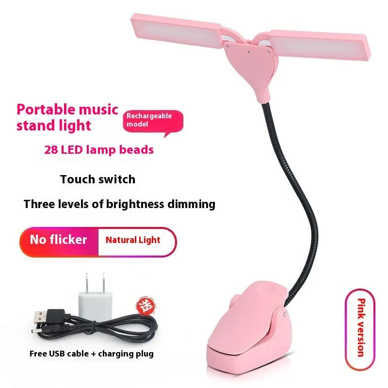 Black clip-on music stand lamp with 28 LEDs, shown with USB cable and AA batteries.