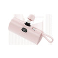 Compact capsule-shaped wireless power bank with digital display and folding plug.