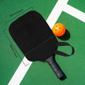 Black Lu Ding rubber badminton racket bag set with lanyard net pocket and pick ball bag on grass