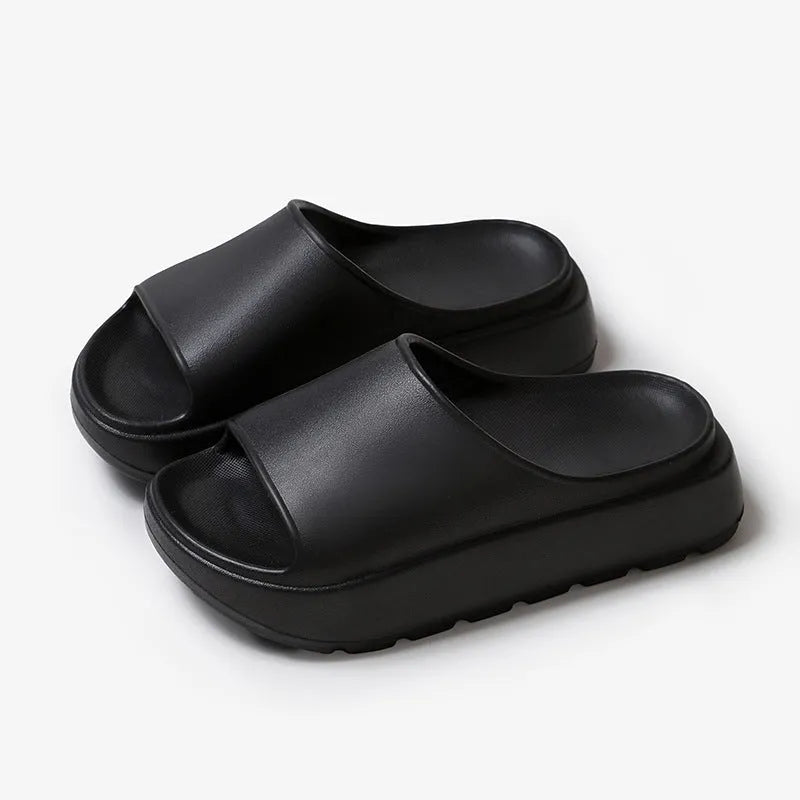 Women's beige fish mouth style slippers with a thick EVA sole on a wooden floor.