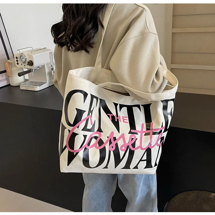 Canvas tote bag with letter print and car stitching detail in medium size 40x7x32cm available in black