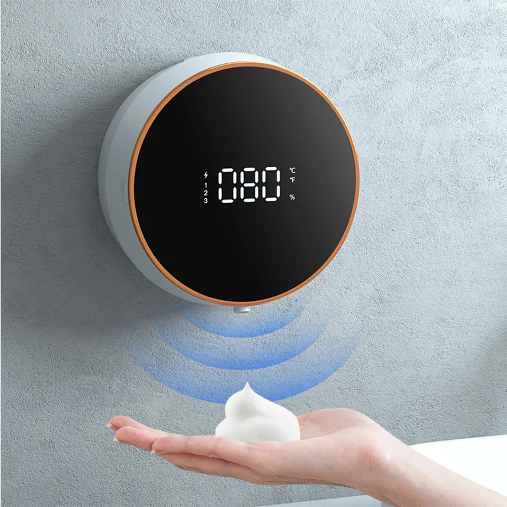 Black and white automatic sensor foam soap dispenser mounted on a wall with USB charging port.