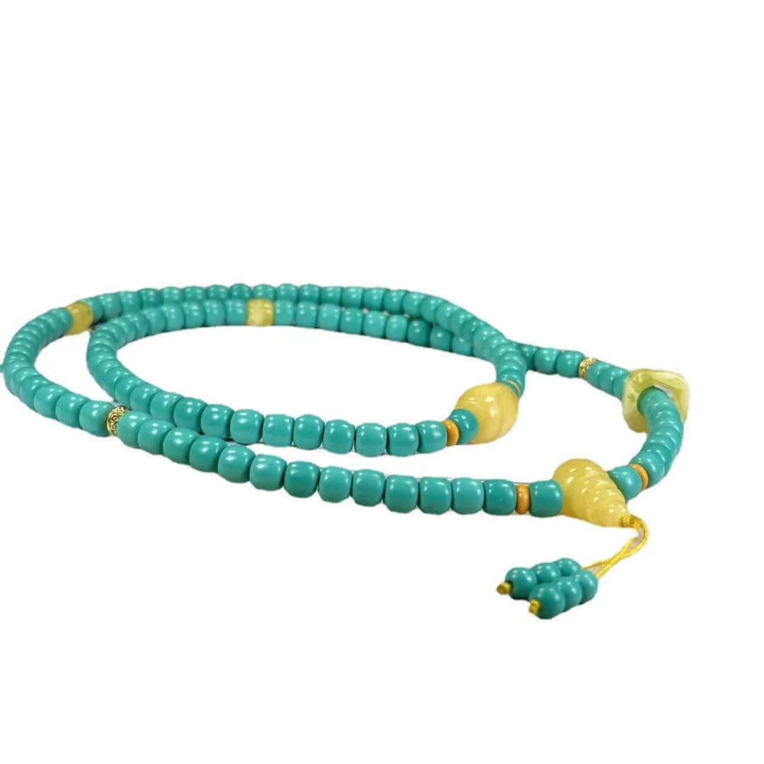 Turquoise necklace with a hand-woven stone mesh flower lucky pendant on a ball bead chain.
