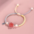 Handmade glass cat paw couple bracelet with red charm on pink or yellow woven cord