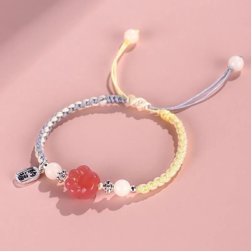Handmade glass cat paw couple bracelet with red charm on pink or yellow woven cord