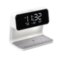 White 3-in-1 bedside lamp with wireless charging pad, LCD clock display, and touch controls.