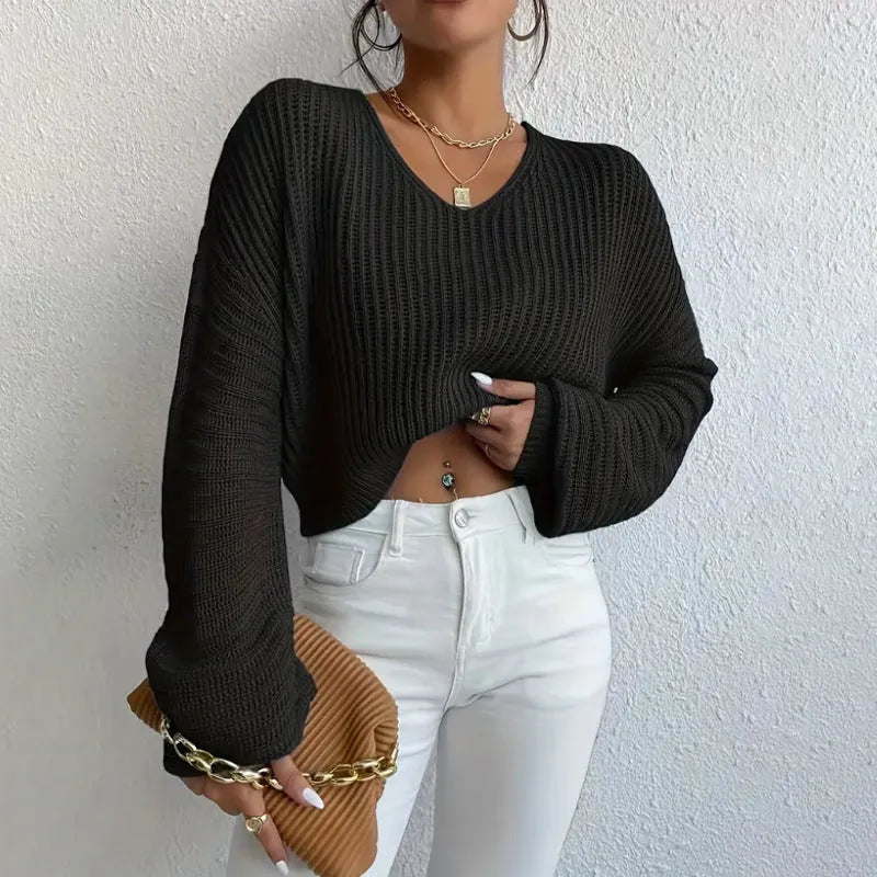 A woman wearing a solid colour long sleeve polyester pullover in a casual, loose fit.