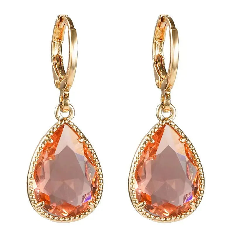 Copper-coloured rare earth metal and glass geometric saturn water drop earrings in multiple colours.