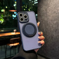 Black frosted phone case for iPhone 17 with a rotating kickstand extended and visible magnetic ring on the back.