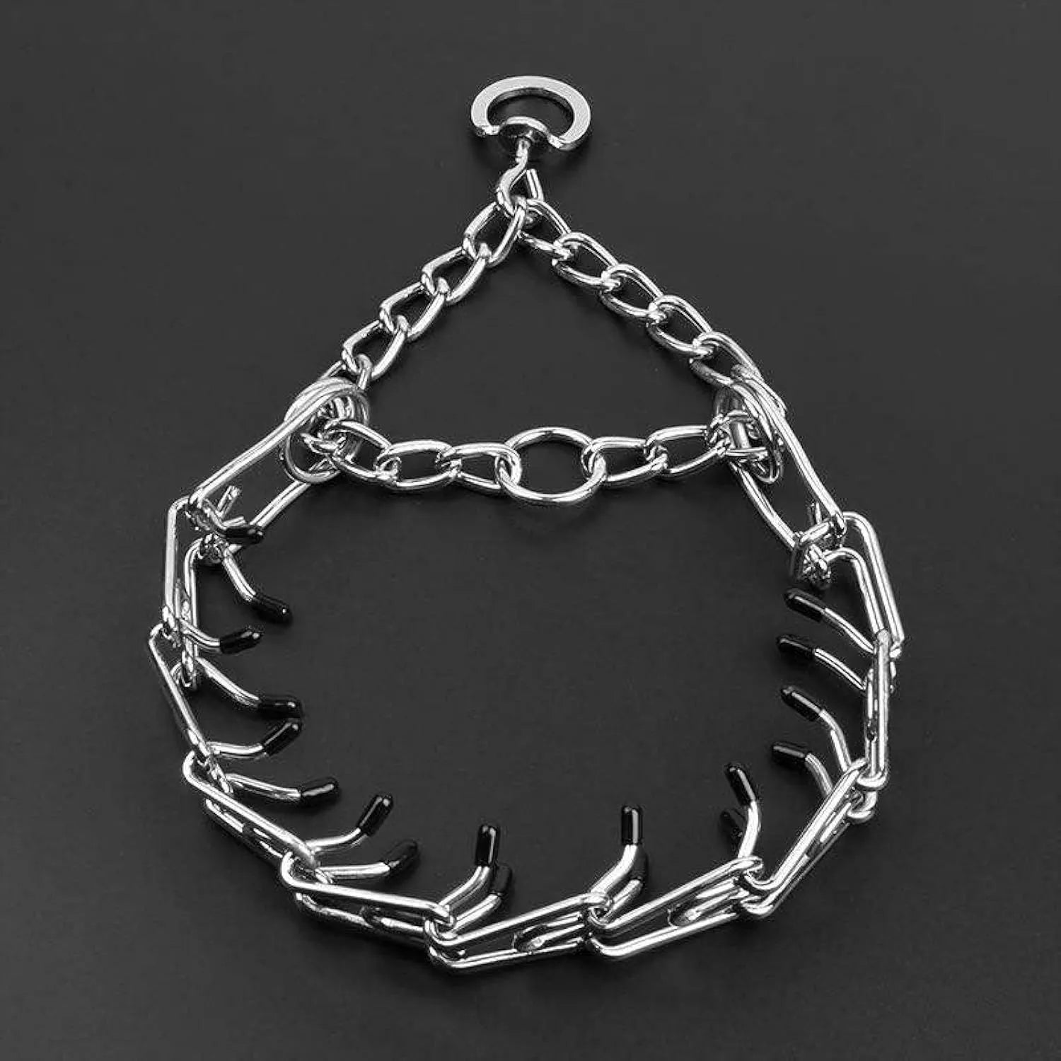 Stainless steel adjustable dog prong training collar with rubber comfort tips on a grey background.