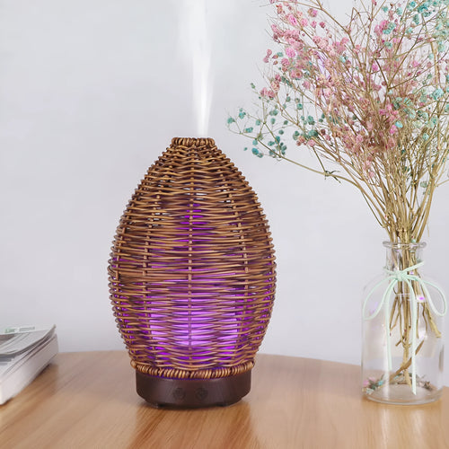 Hollow rattan aroma diffuser with light wood grain finish, showing 100ml water tank