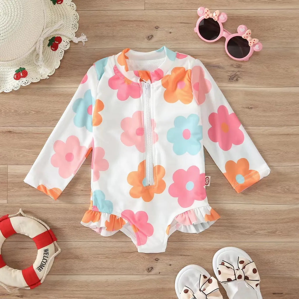 Girls' one-piece floral zipper romper swimsuit in pink, full front view, polyester spandex fabric