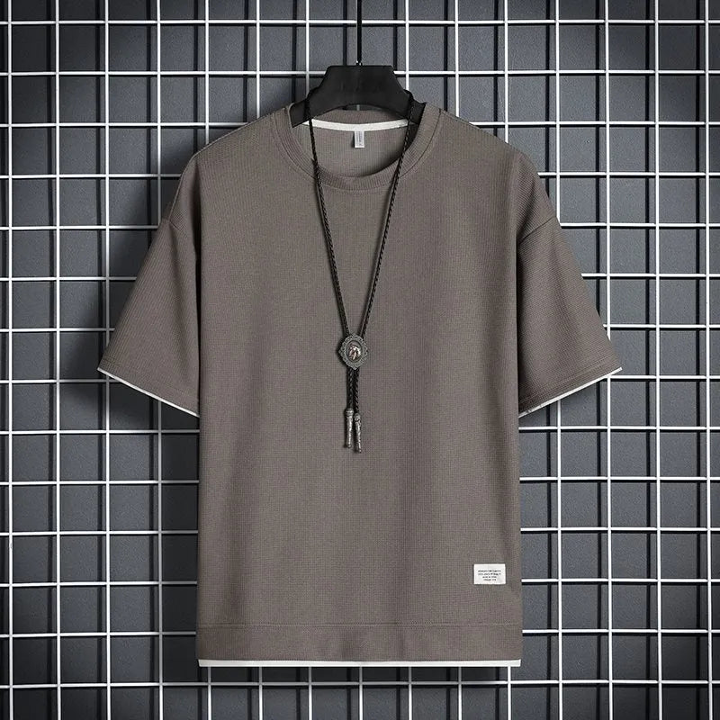Half sleeve loose pullover top in polyester, available in seven colours and sizes M to 5XL