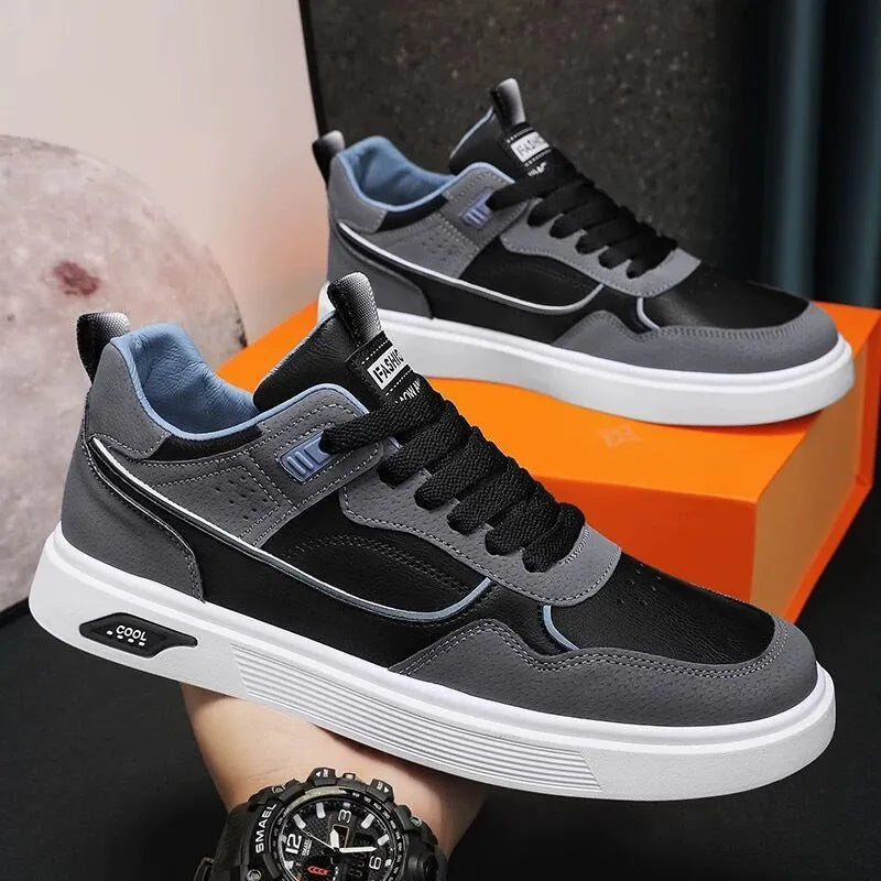 Men's low-top canvas board shoes in grey with leather stitching detail on a white background.