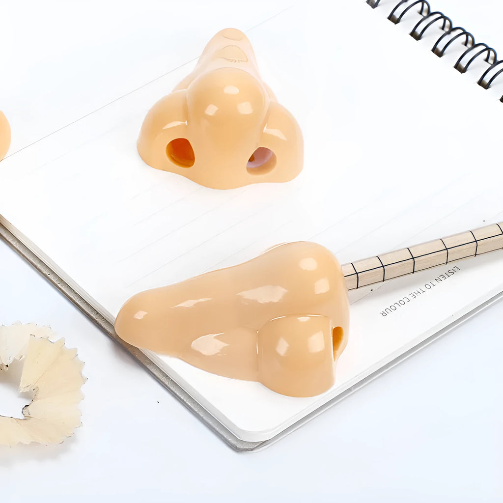 Flesh colour plastic manual pencil sharpener with big nostril, showing geometry shape.