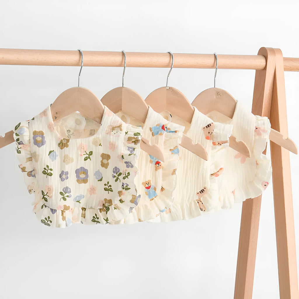 Six multi-coloured cotton muslin baby bibs with animal bandana designs and adjustable snaps