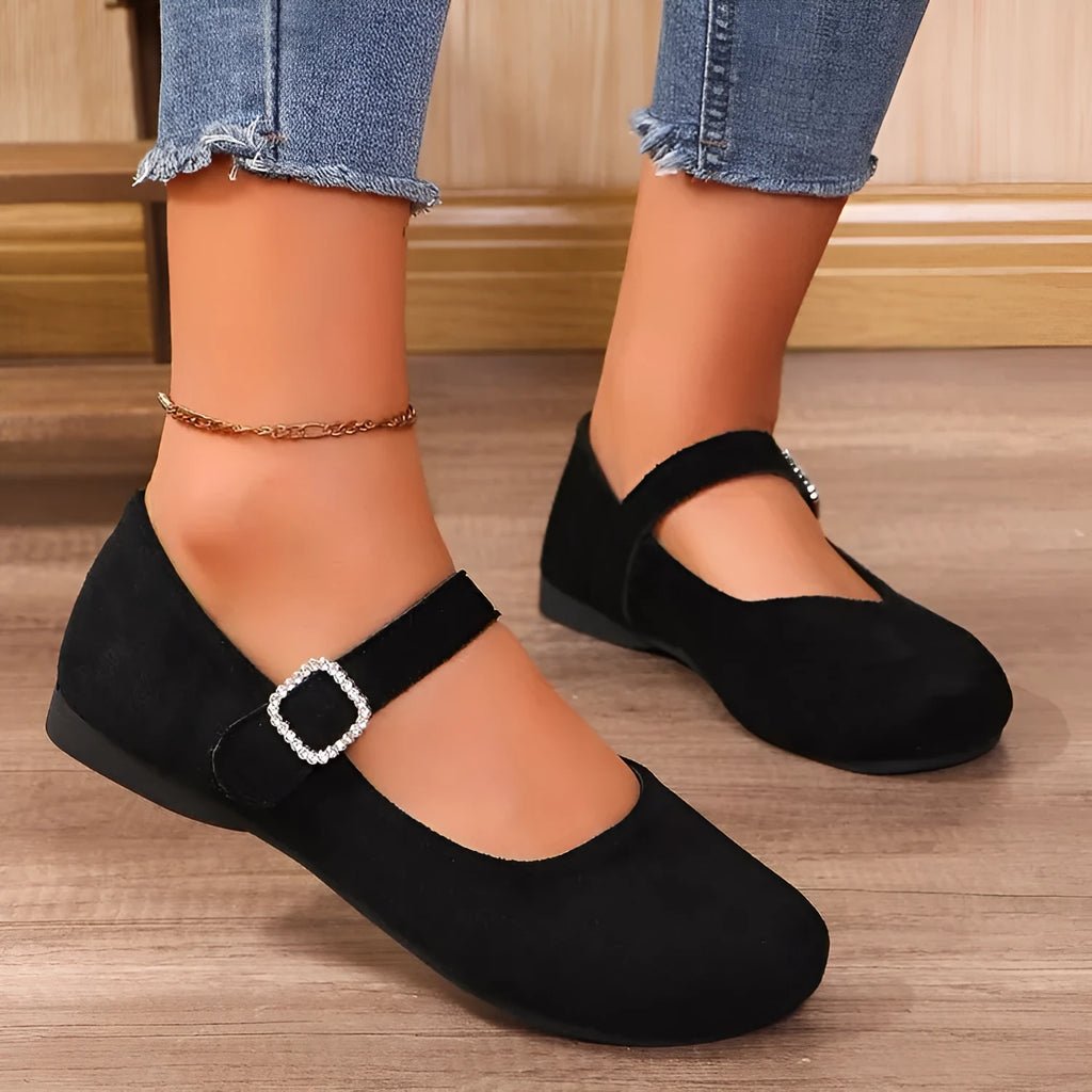 Black canvas low-top flat fisherman shoes with a rubber sole on a plain background.