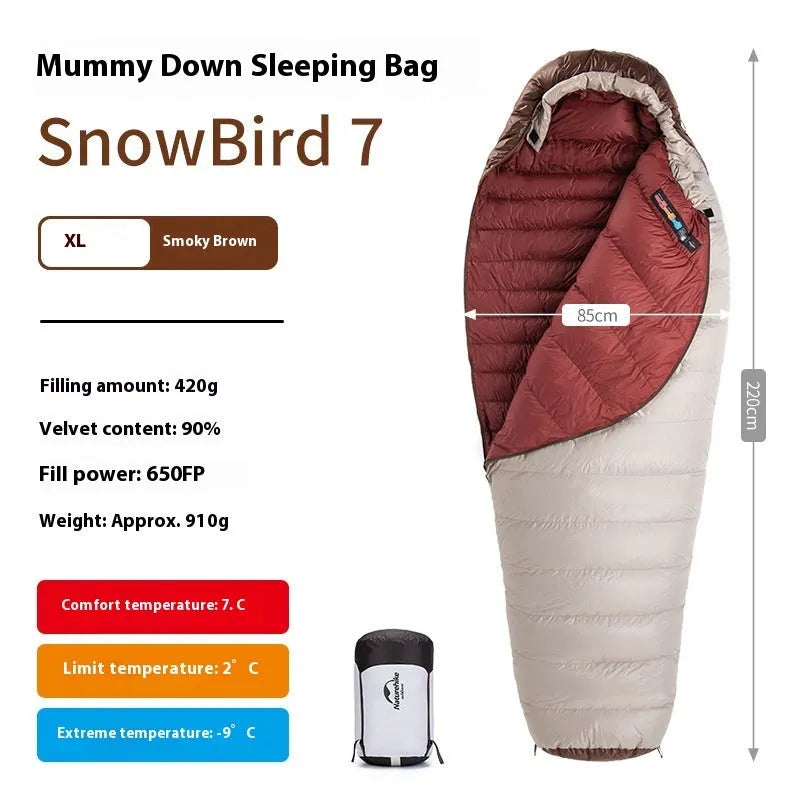 Goose down mummy sleeping bag in a stuff sack, part of the snowbird range for camping.